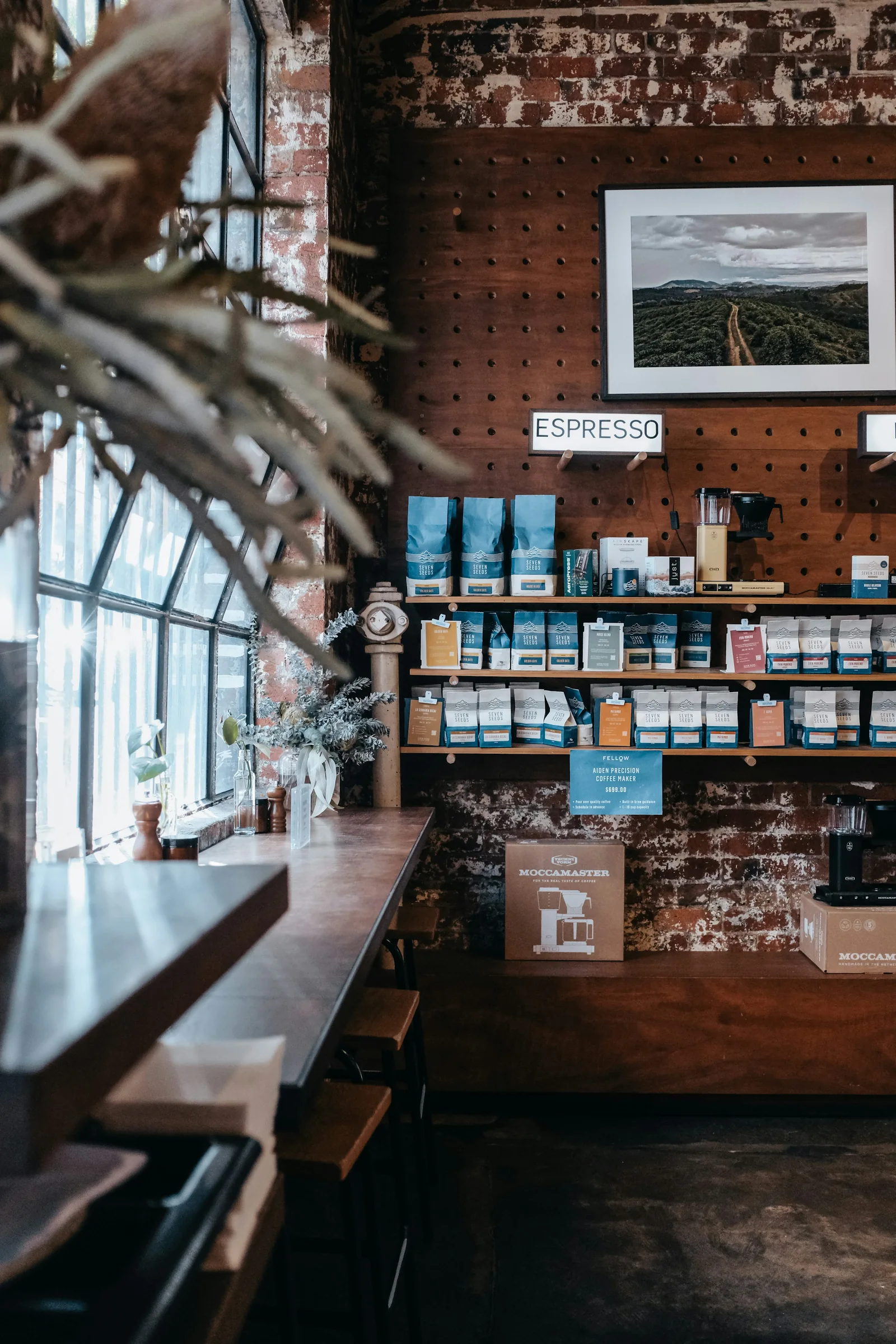 Window seating, exposed brick and coffee shelves in a Carlton café